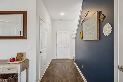 a spacious bedroom with a bed a couch and a chandelier