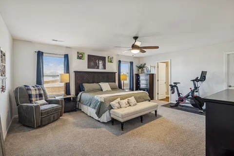 a bathroom with a sink a toilet and a large mirror