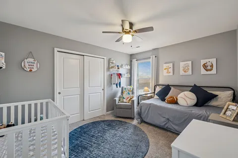 a bedroom with two beds and a window