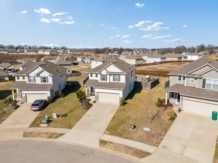an aerial view of a residential houses with outdoor space