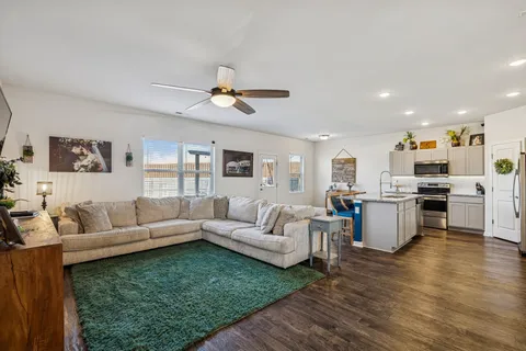 a living room with furniture and kitchen view