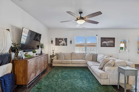 a living room with furniture and a flat screen tv