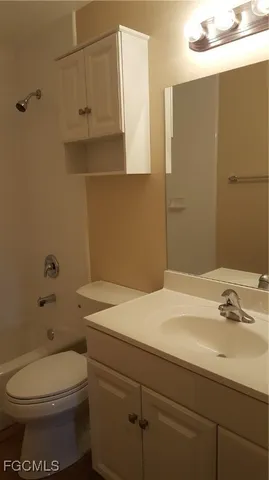 a bathroom with a sink a toilet and vanity