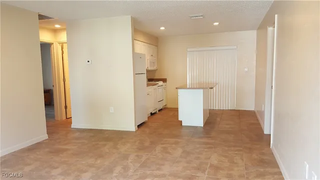 a view of a hallway with wooden cabinets
