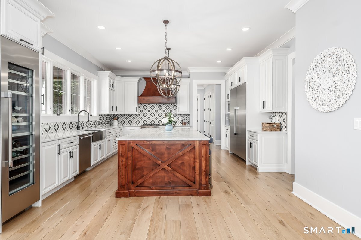 2 Pond View Lane Sherman, CT 06784 - Photo 10 of 40 a kitchen with stainless steel appliances granite countertop a refrigerator a oven a sink and white cabinets with wooden floor