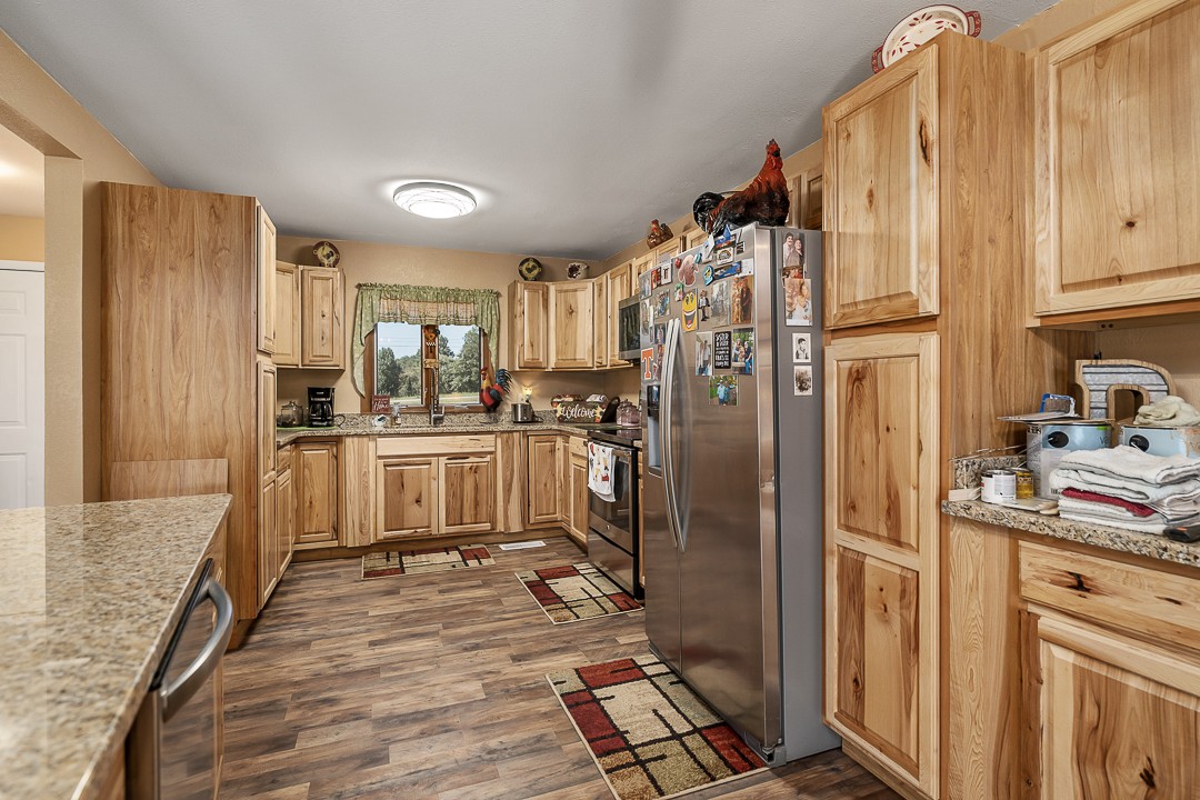 2711 Sullivan Knowles Road Sparta, TN 38583 - Photo 25 of 42 a kitchen with refrigerator and cabinets