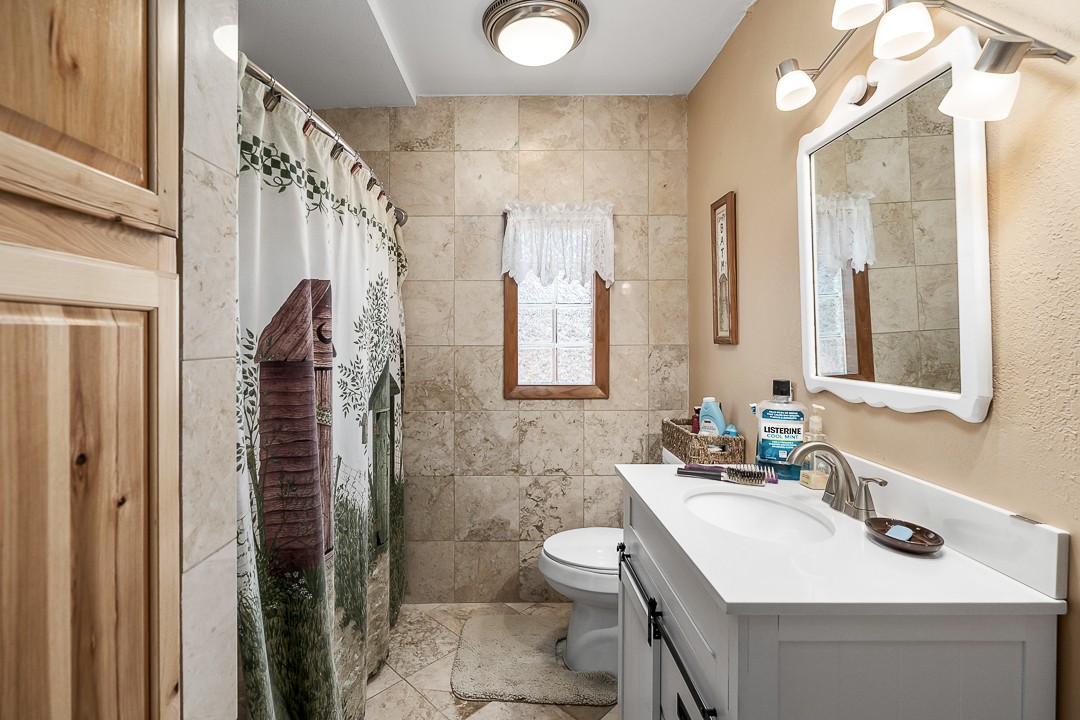 2711 Sullivan Knowles Road Sparta, TN 38583 - Photo 29 of 42 a bathroom with a sink vanity mirror and toilet