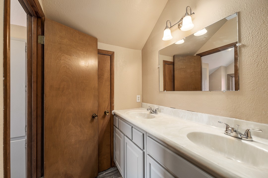 2711 Sullivan Knowles Road Sparta, TN 38583 - Photo 33 of 42 a bathroom with a double vanity sink and a mirror