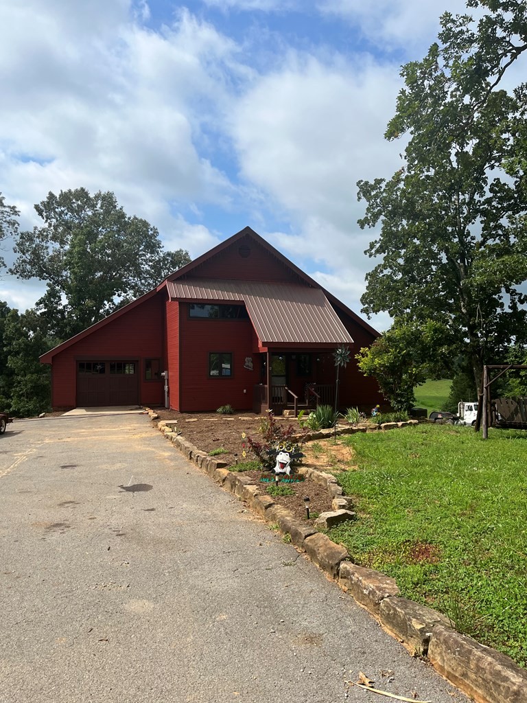2711 Sullivan Knowles Road Sparta, TN 38583 - Photo 10 of 42 a front view of a house with a yard and garage