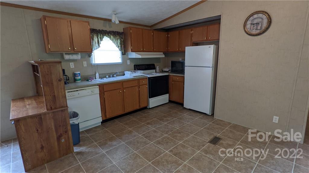 1351 Liberty Road Chester, SC 29706 - Photo 8 of 28 a kitchen with stainless steel appliances granite countertop a refrigerator a stove a sink and a microwave