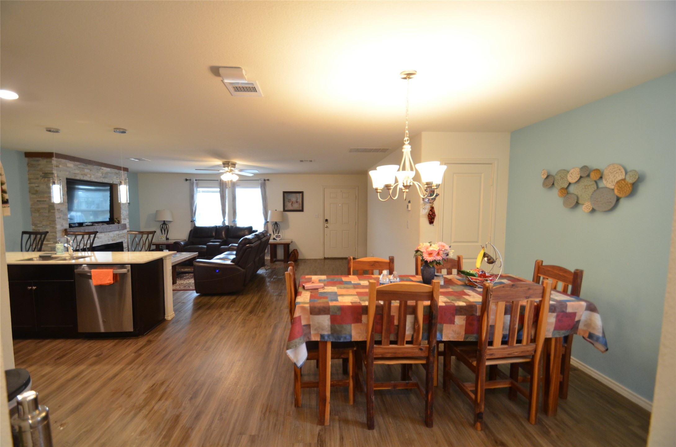 13706 Mussel Run Elgin, TX 78621 - Photo 12 of 34 a view of a dining room with furniture a chandelier and wooden floor