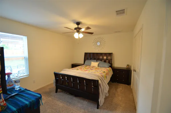 a bedroom with a bed and window