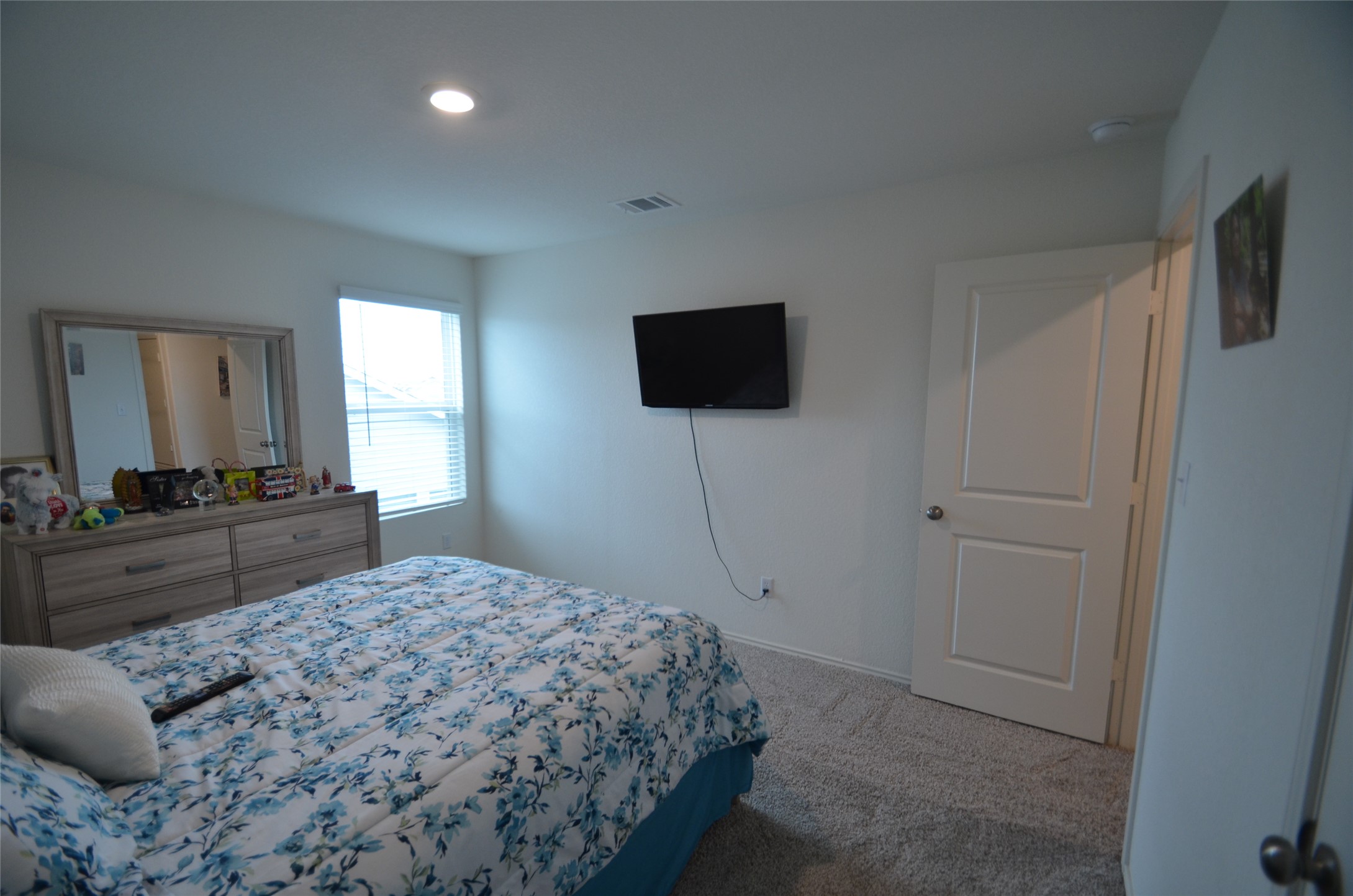 13706 Mussel Run Elgin, TX 78621 - Photo 17 of 34 a bedroom with a bed and a flat screen tv