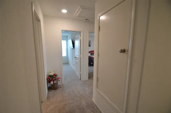 a view of a hallway with a livingroom and a chair