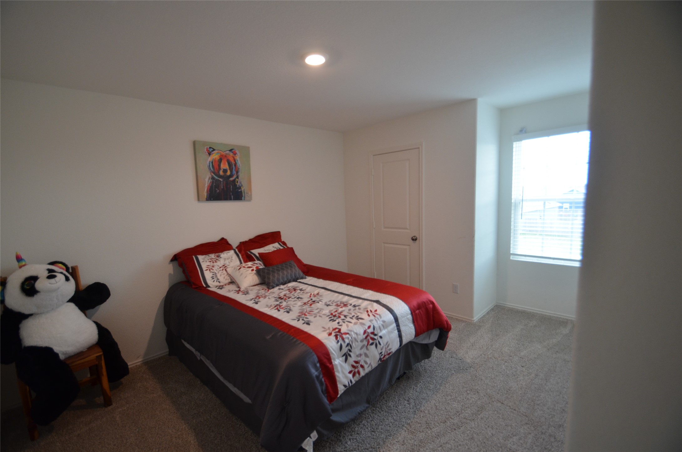 13706 Mussel Run Elgin, TX 78621 - Photo 20 of 34 a bed sitting in a bedroom next to a window