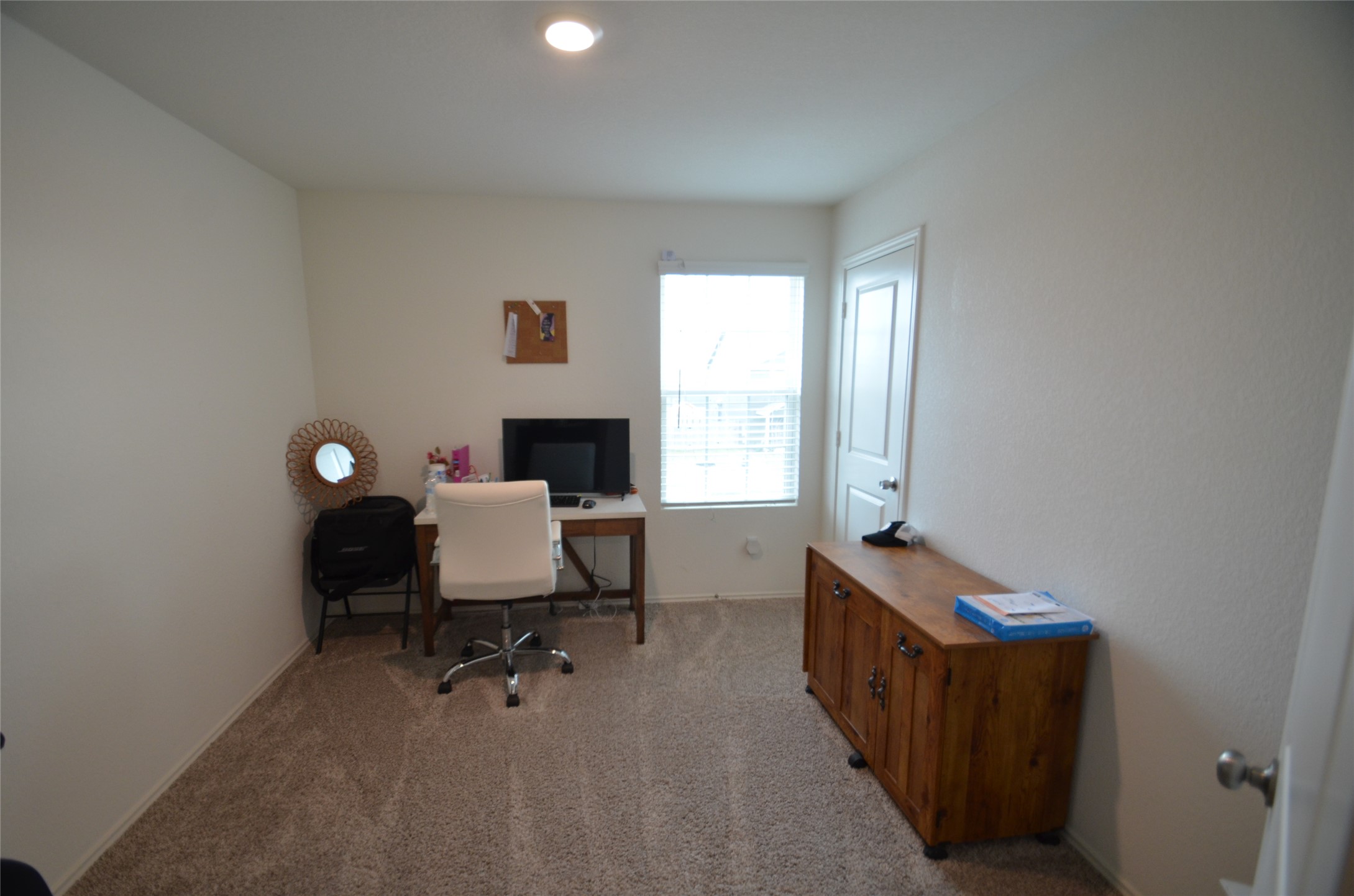 13706 Mussel Run Elgin, TX 78621 - Photo 22 of 34 a view of a workspace with furniture and a window