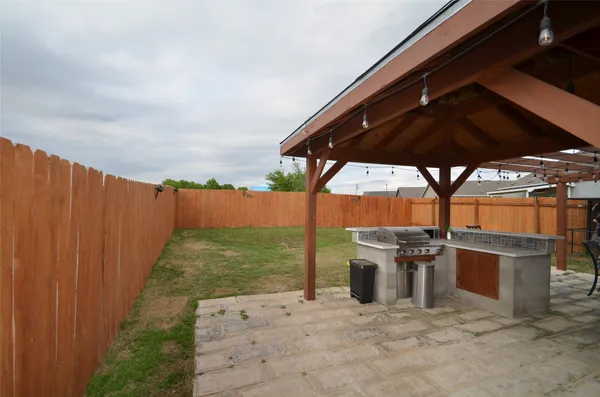 a view of a backyard with seating area