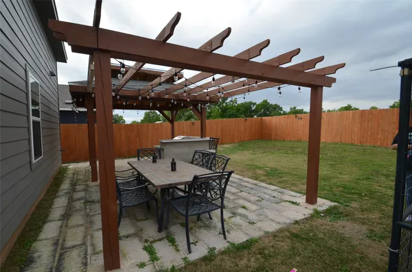 a patio with yard glass top table and chairs