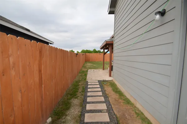 a view of a pathway with a backyard