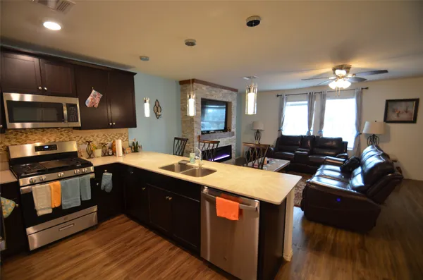 a large kitchen with lots of counter space a sink and appliances