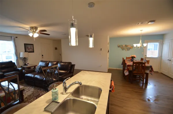 a living room with furniture a fireplace and wooden floor