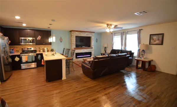 a living room with lots of furniture and kitchen view