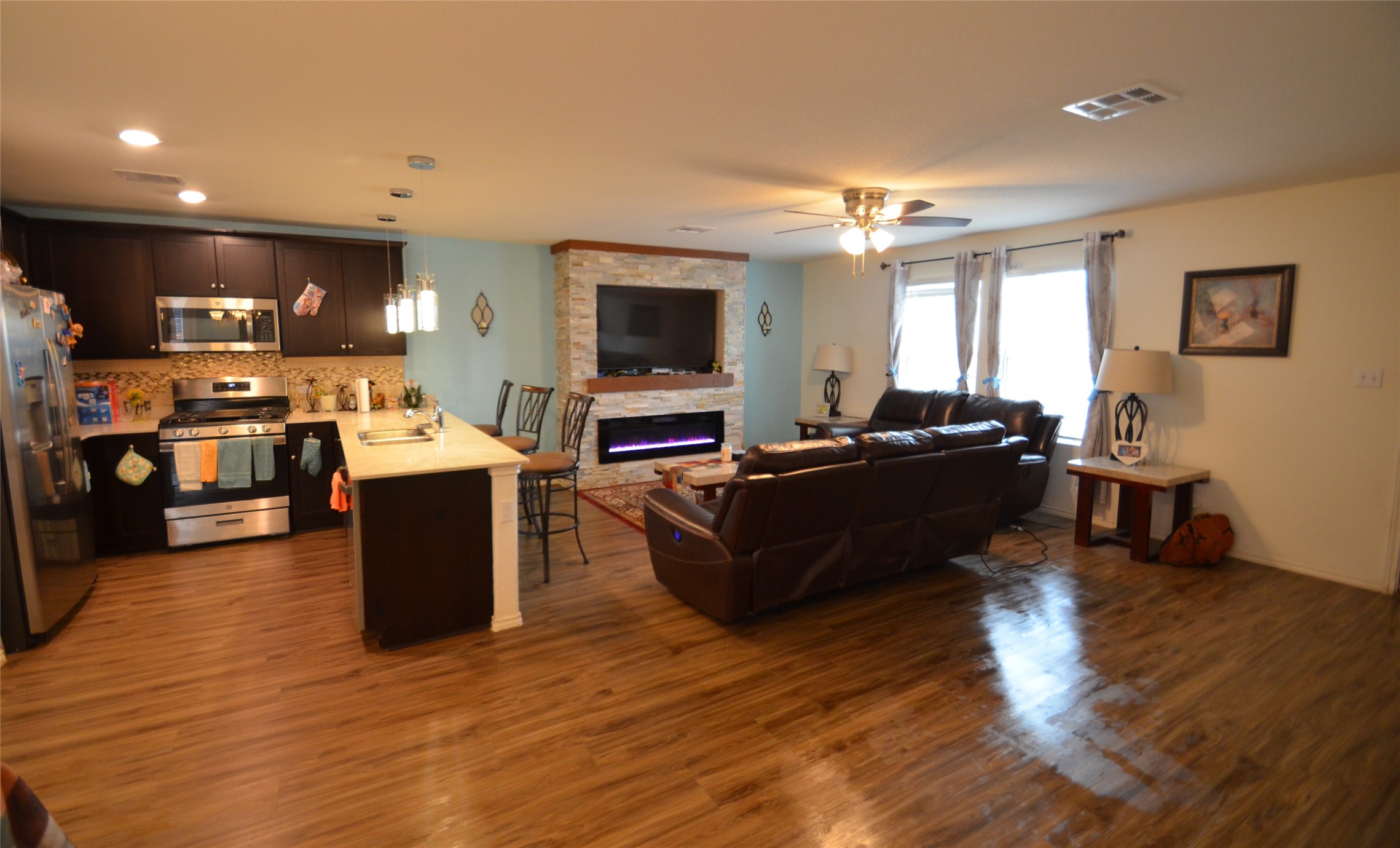13706 Mussel Run Elgin, TX 78621 - Photo 8 of 34 a living room with lots of furniture and kitchen view
