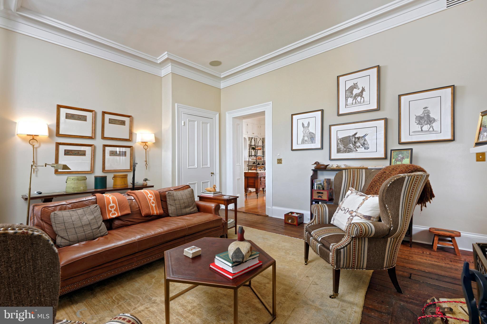 7064 Young Road The Plains, VA 20198 - Photo 15 of 89 a living room with furniture a couch and paintings on the wall