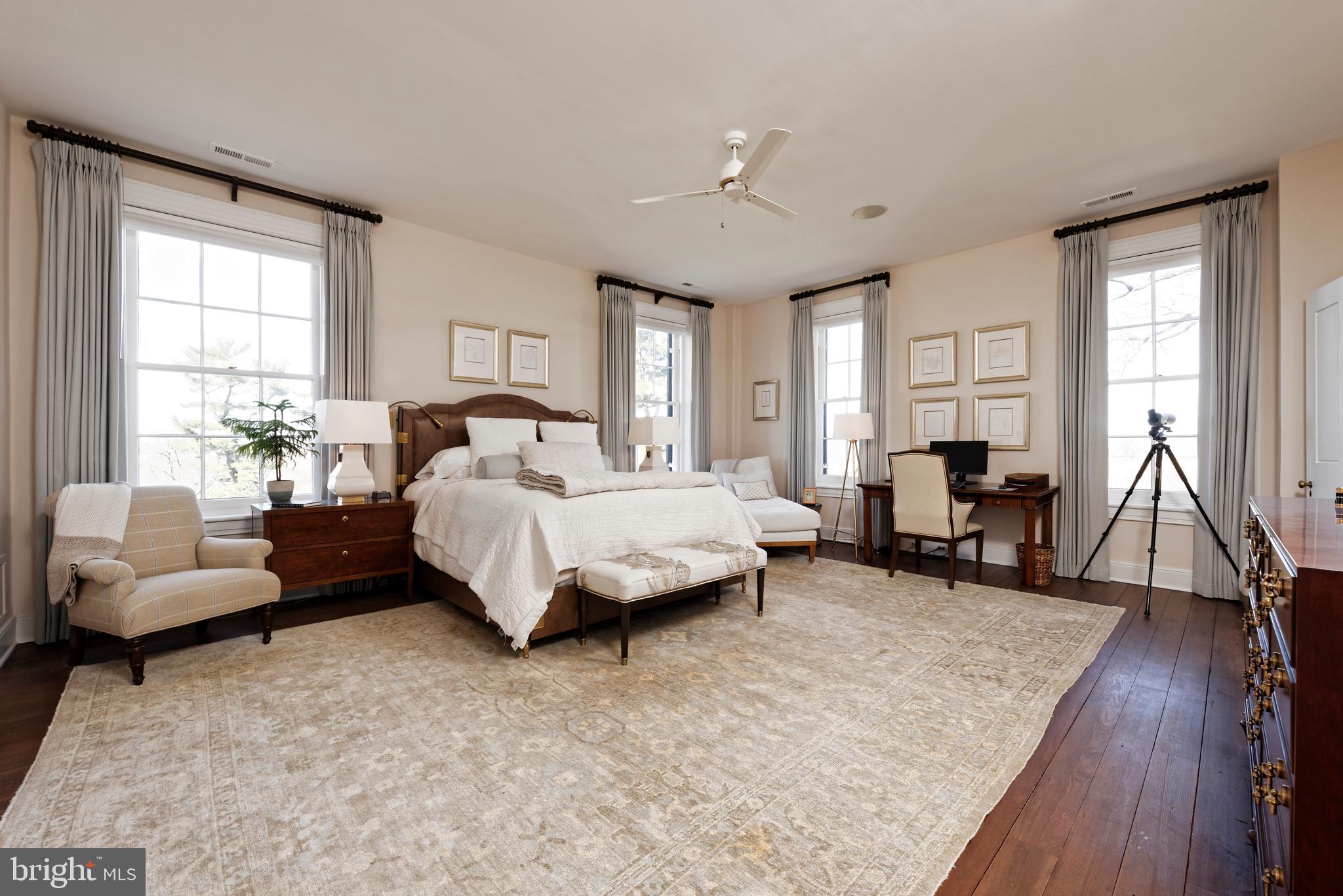 7064 Young Road The Plains, VA 20198 - Photo 23 of 89 a spacious bedroom with a bed a couch and a large window
