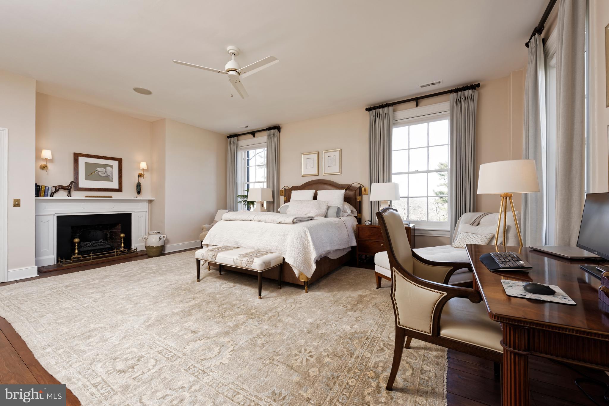 7064 Young Road The Plains, VA 20198 - Photo 24 of 89 a spacious bedroom with a bed a table and a fireplace