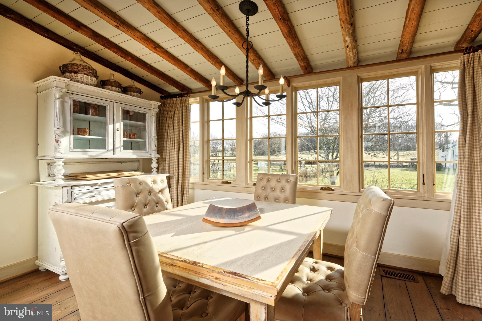 7064 Young Road The Plains, VA 20198 - Photo 56 of 89 a dining room with furniture large windows and wooden floor