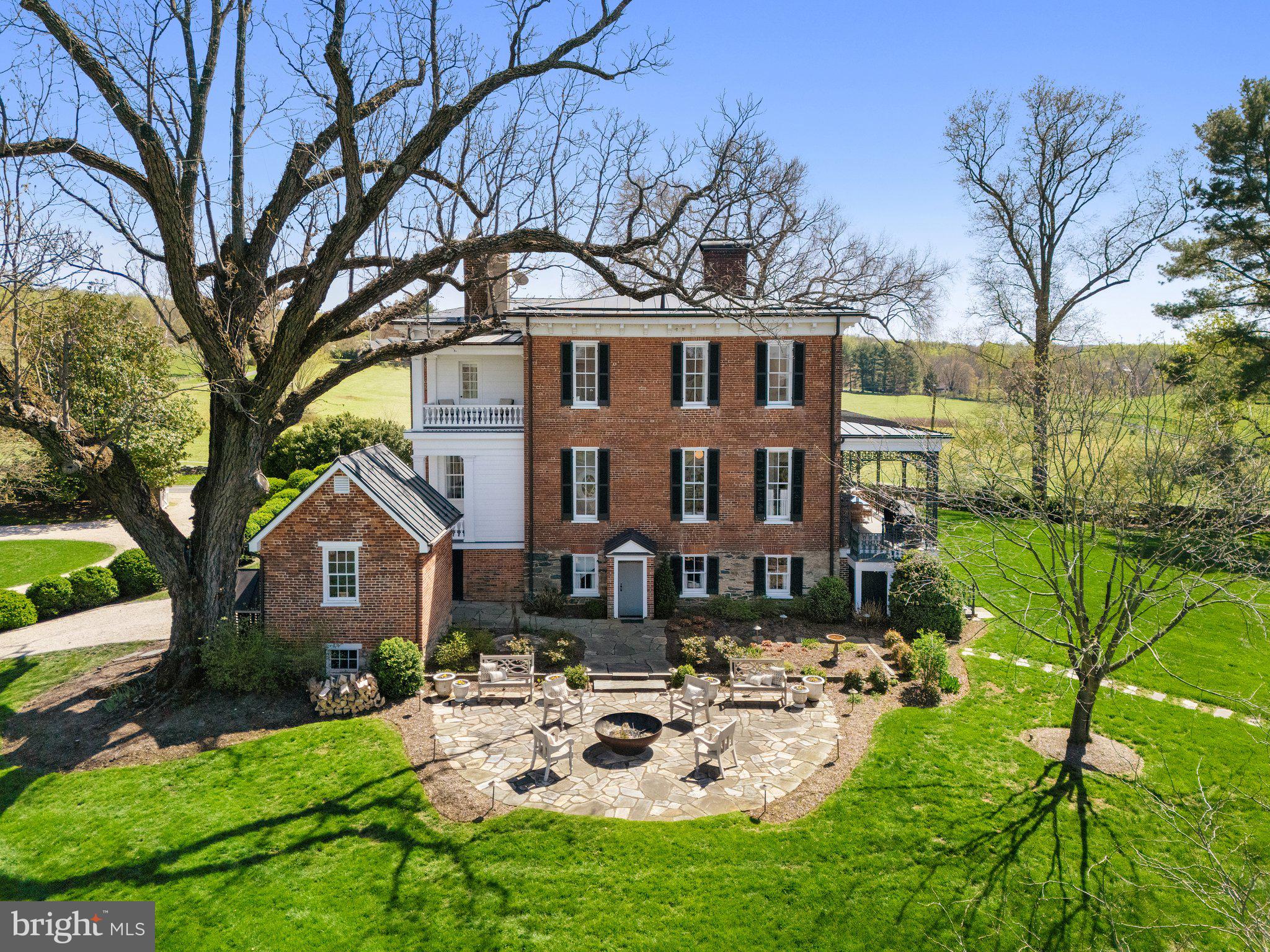 7064 Young Road The Plains, VA 20198 - Photo 67 of 89 a view of a white house with a yard and a large tree