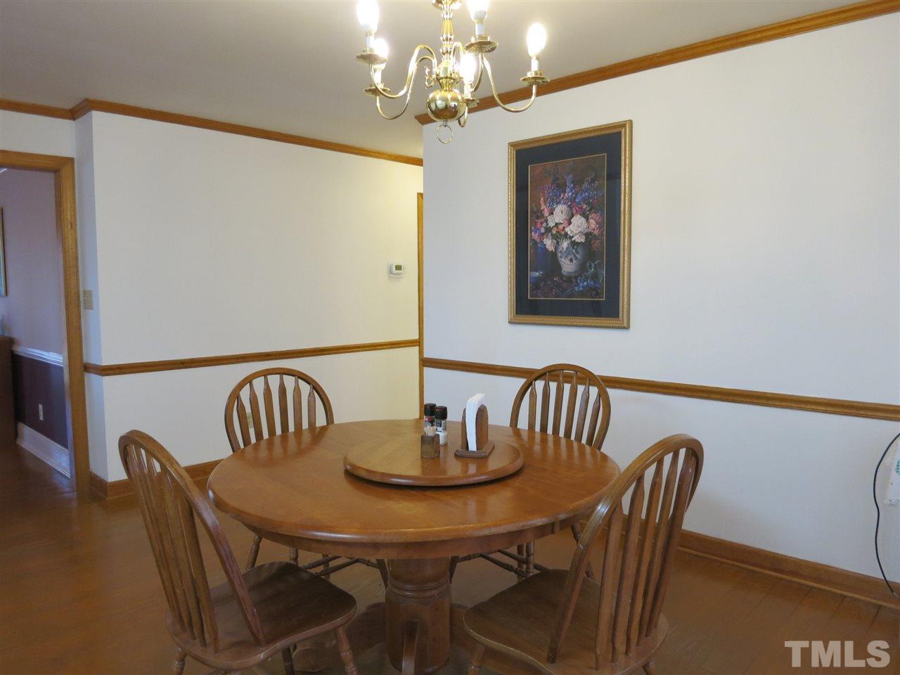 4300 Quarry Road Zebulon, NC 27597 - Photo 5 of 25 a view of a dining room with furniture and chandelier