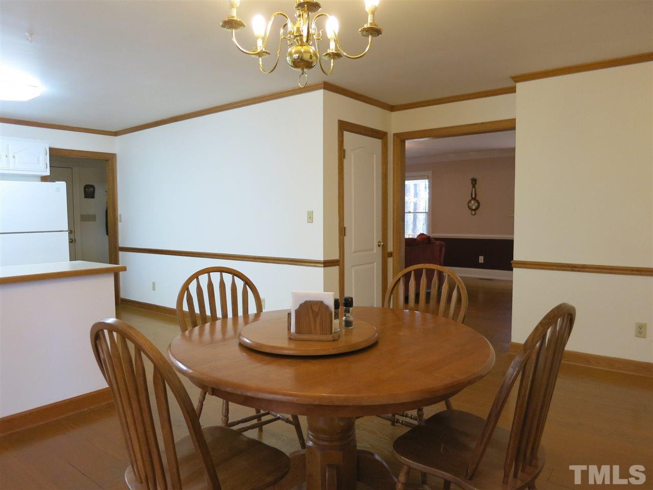 4300 Quarry Road Zebulon, NC 27597 - Photo 6 of 25 a view of a dining room with furniture and chandelier