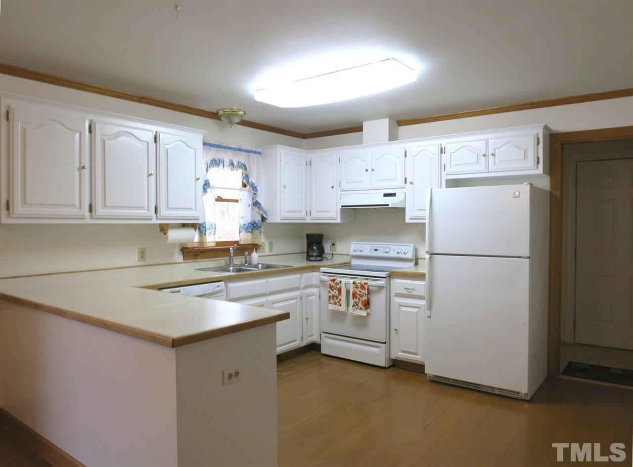 4300 Quarry Road Zebulon, NC 27597 - Photo 8 of 25 a kitchen with stainless steel appliances granite countertop refrigerator sink and cabinets
