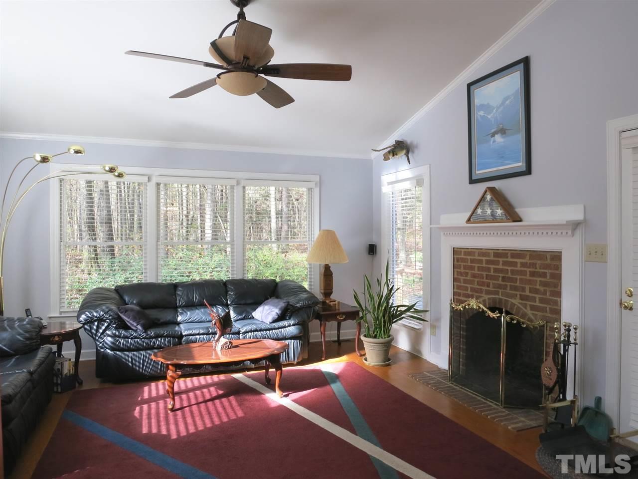 4300 Quarry Road Zebulon, NC 27597 - Photo 10 of 25 a living room with furniture a fireplace and a floor to ceiling window