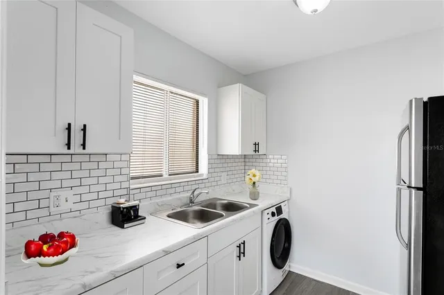 a bathroom with a sink and a washing machine