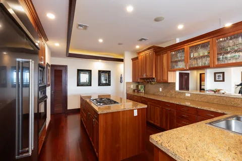 a kitchen with stainless steel appliances granite countertop a sink stove and refrigerator