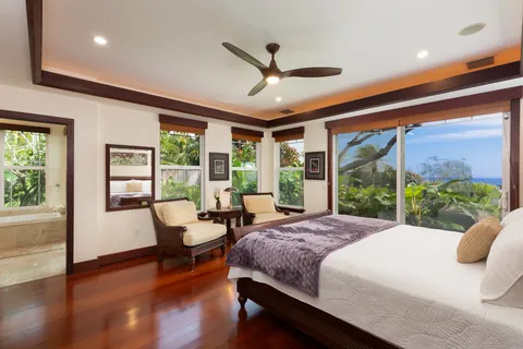 a bedroom with a large bed and a large window