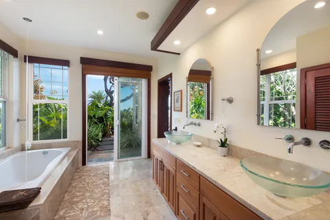 a bathroom with a granite countertop sink and a large mirror