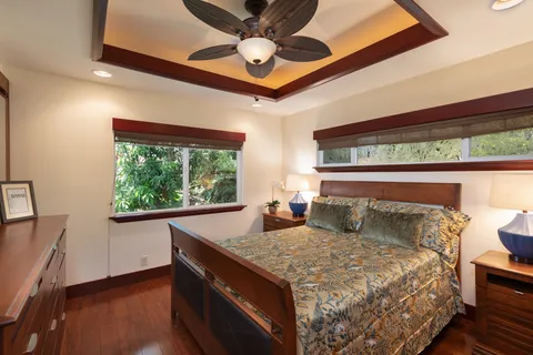 a bed sitting in a bedroom next to a window