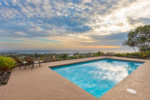 a view of a swimming pool with an outdoor seating