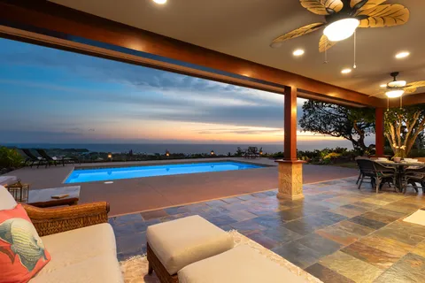 a view of a swimming pool with an outdoor seating