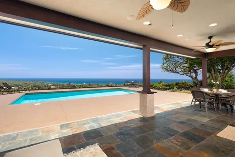 a view of a swimming pool and an outdoor seating
