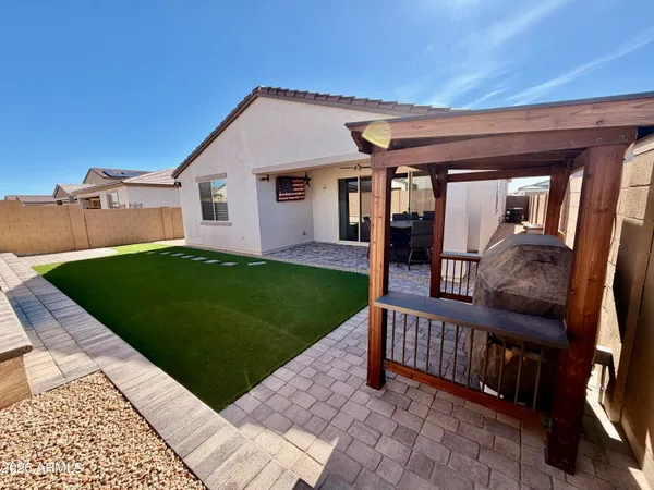 a view of a house with a yard and deck