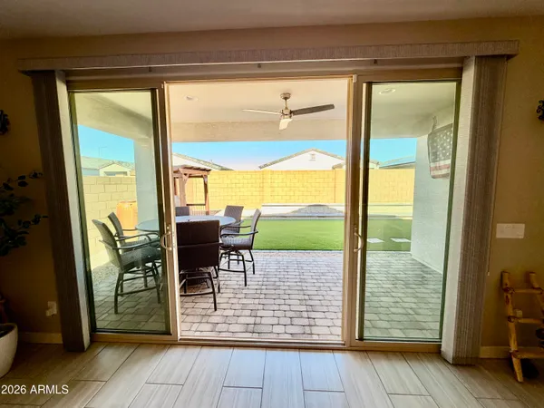 a view of a porch with chairs and backyard