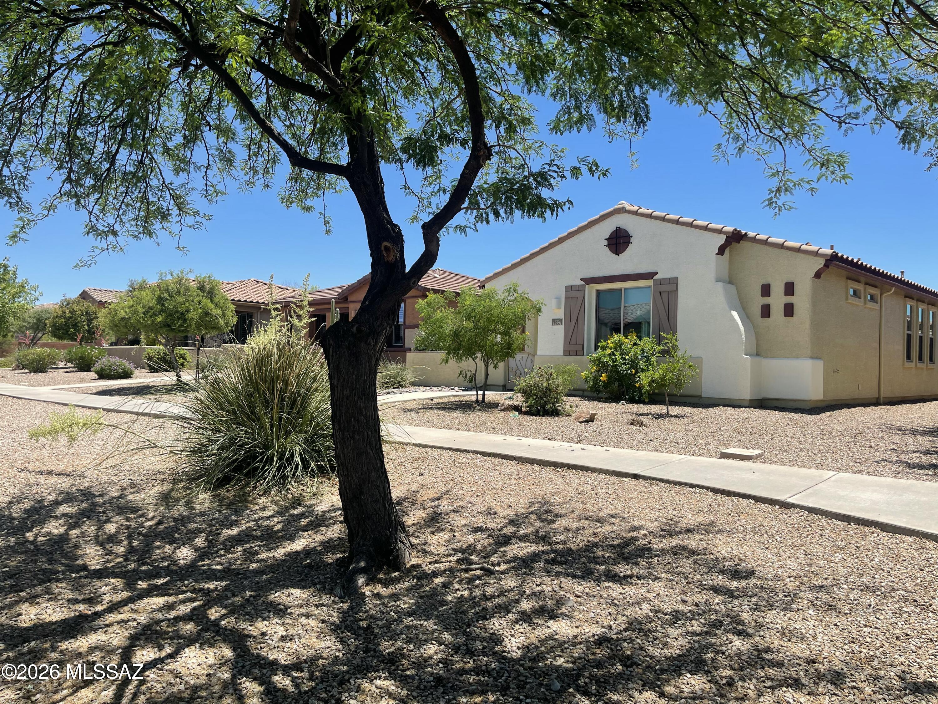 13991 East Cheavront Loop Vail, AZ 85641 - Photo 35 of 47 a front view of a house with a yard and an trees