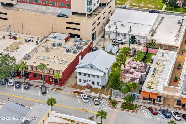 an aerial view of a building with parking