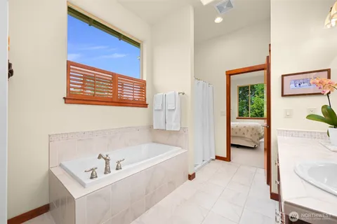 a en suite bathroom with a bathtub and sink