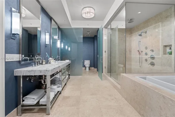 a en suite bathroom with a double vanity sink and a mirror